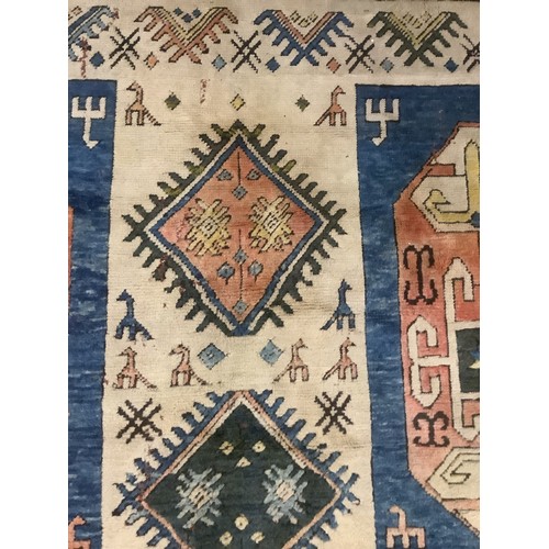 348 - large wool rug, 256cm x 340cm. In fair condition, a few stains, loss of pile, damage to the fringe