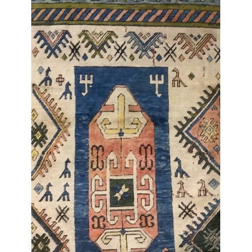 348 - large wool rug, 256cm x 340cm. In fair condition, a few stains, loss of pile, damage to the fringe