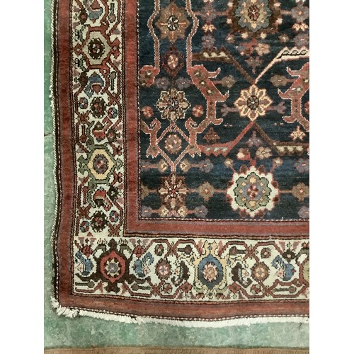 385 - A Persian style rug with all over geometric pattern of browns, blues and red colour, and cream groun... 