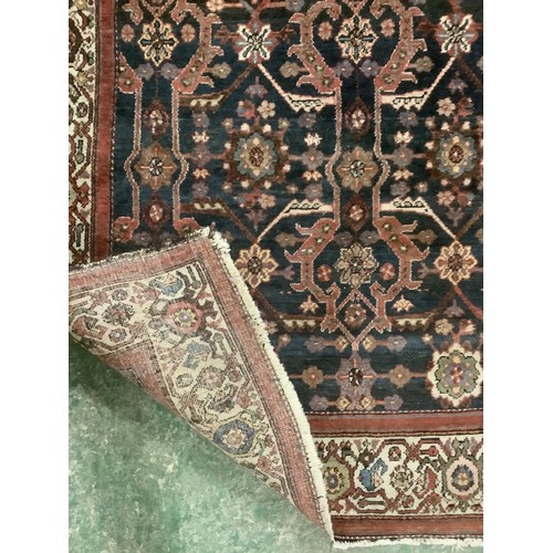 385 - A Persian style rug with all over geometric pattern of browns, blues and red colour, and cream groun... 