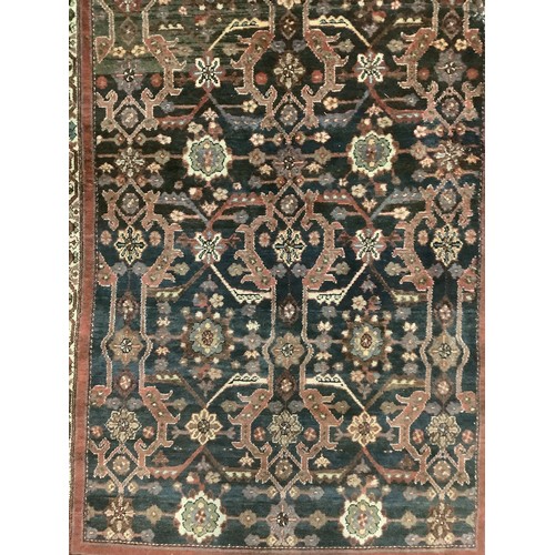 385 - A Persian style rug with all over geometric pattern of browns, blues and red colour, and cream groun... 