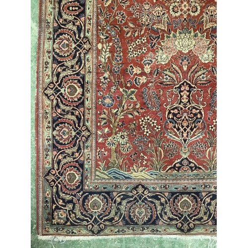 386 - A Persian style red ground rug, with blue stylized borders, with some all over general wear, 132 cm ... 