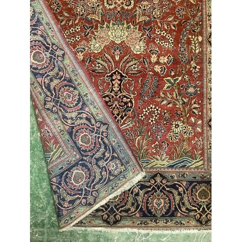 386 - A Persian style red ground rug, with blue stylized borders, with some all over general wear, 132 cm ... 