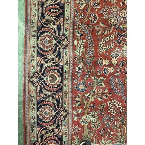 386 - A Persian style red ground rug, with blue stylized borders, with some all over general wear, 132 cm ... 