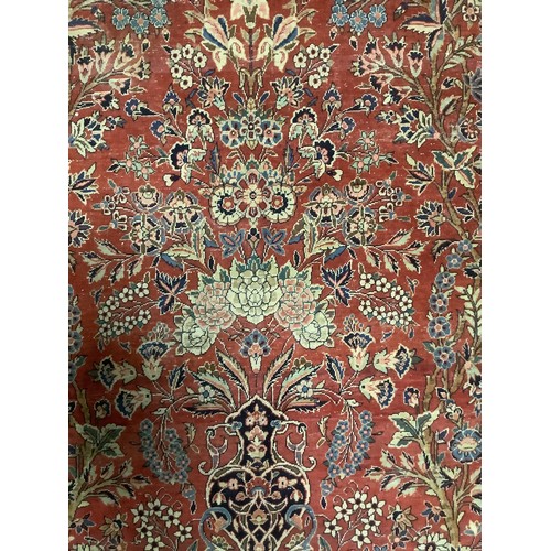 386 - A Persian style red ground rug, with blue stylized borders, with some all over general wear, 132 cm ... 