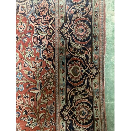 386 - A Persian style red ground rug, with blue stylized borders, with some all over general wear, 132 cm ... 