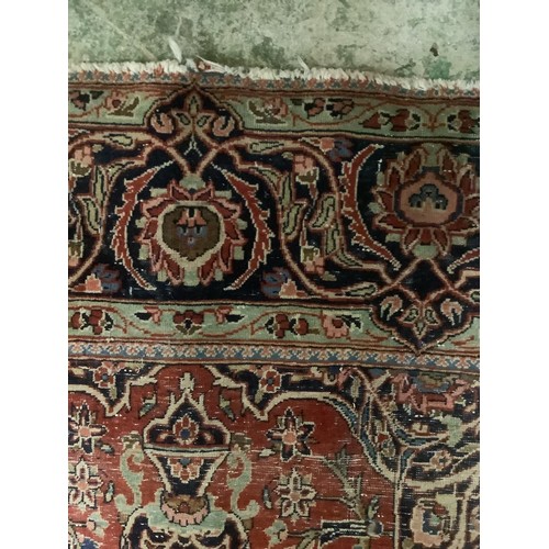 386 - A Persian style red ground rug, with blue stylized borders, with some all over general wear, 132 cm ... 