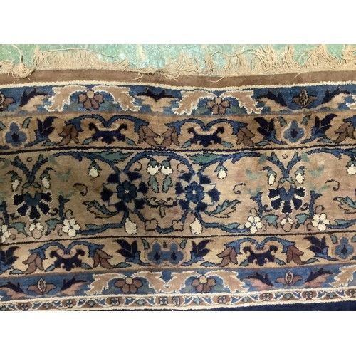 384 - A large Persian style blue ground rug, notable all over wear 255 cm x 404 cm