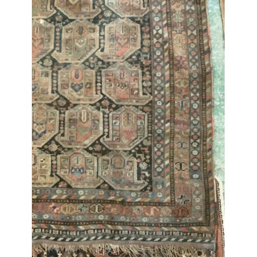 383 - A large Persian style carpet, with all over brown ground and geometric pattern and borders, and much... 