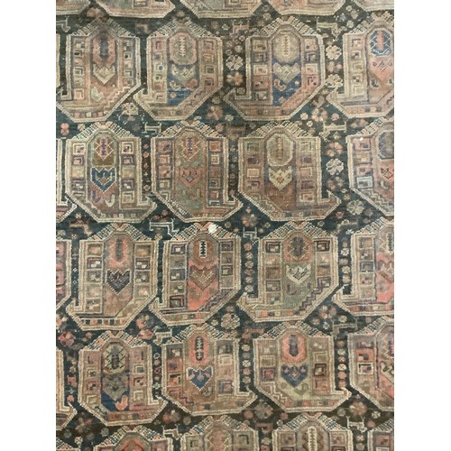 383 - A large Persian style carpet, with all over brown ground and geometric pattern and borders, and much... 