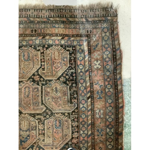 383 - A large Persian style carpet, with all over brown ground and geometric pattern and borders, and much... 