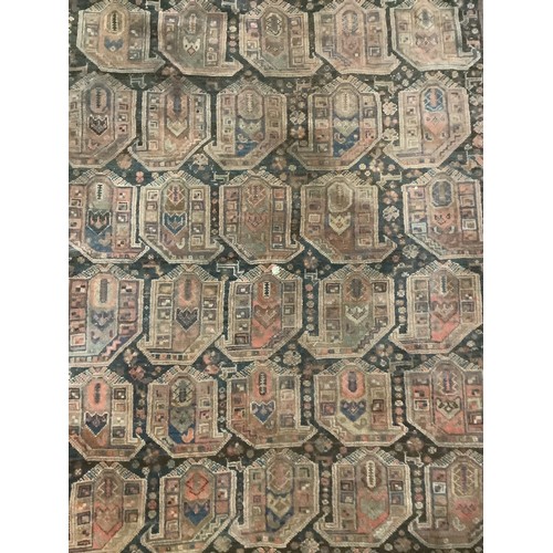 383 - A large Persian style carpet, with all over brown ground and geometric pattern and borders, and much... 