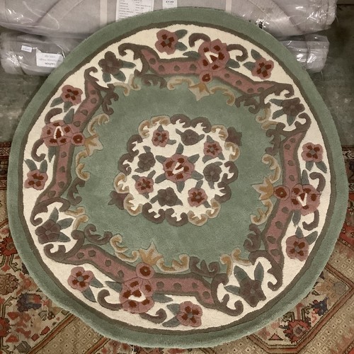 389 - Four 100% wool circular rugs, 118cm, 2 red, 2 green, new.