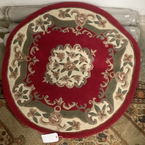 389 - Four 100% wool circular rugs, 118cm, 2 red, 2 green, new.