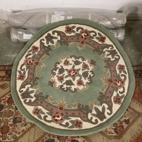 389 - Four 100% wool circular rugs, 118cm, 2 red, 2 green, new.