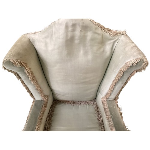 501 - A pair of C18th upright high winged back armchairs, upholstered in a faded light green silk, on carv... 