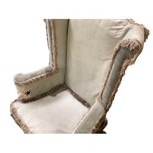 501 - A pair of C18th upright high winged back armchairs, upholstered in a faded light green silk, on carv... 