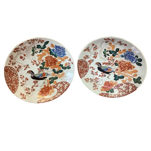 101 - A pair of Oriental chargers, Japanese Kutani style, decorated in the Imari palette, exotic birds and... 