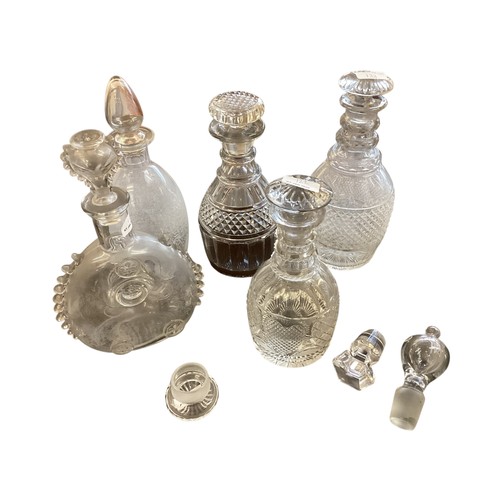 122 - Three cut glass decanters plus 3 various decanter stoppers, and another decanter in the style of Rem... 