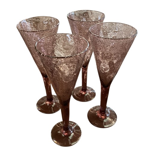 112 - A quantity of glassware to include a good set of six etched fluted champagne glasses, 4 purple wine ... 