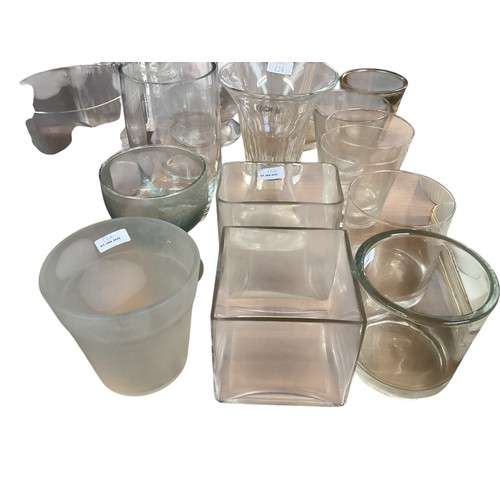 124 - A large quantity of glasswares to include 7 tall cylindrical glass flower vases, and 3 heavy glass c... 