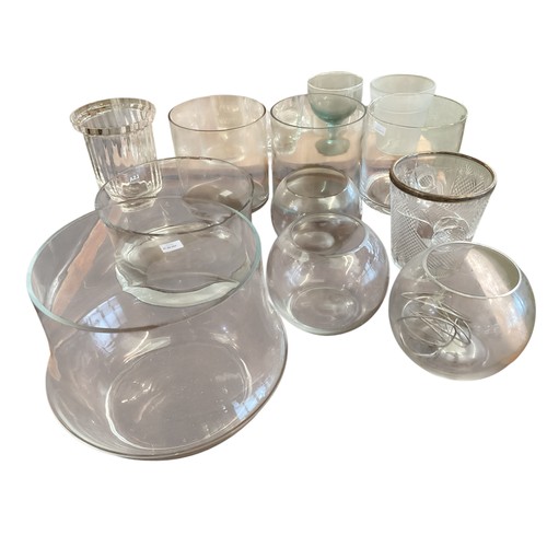 124 - A large quantity of glasswares to include 7 tall cylindrical glass flower vases, and 3 heavy glass c... 