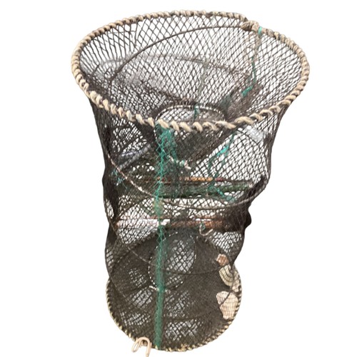 253 - A quantity of old fishing equipment, including nets, rods landing net, lobster pot etc