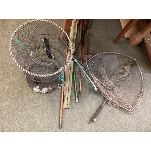 253 - A quantity of old fishing equipment, including nets, rods landing net, lobster pot etc