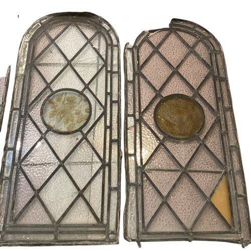 255 - Two pairs of arched lead lined stained glass windows, each with circular etched panels to centre, th... 