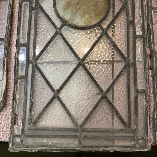 255 - Two pairs of arched lead lined stained glass windows, each with circular etched panels to centre, th... 