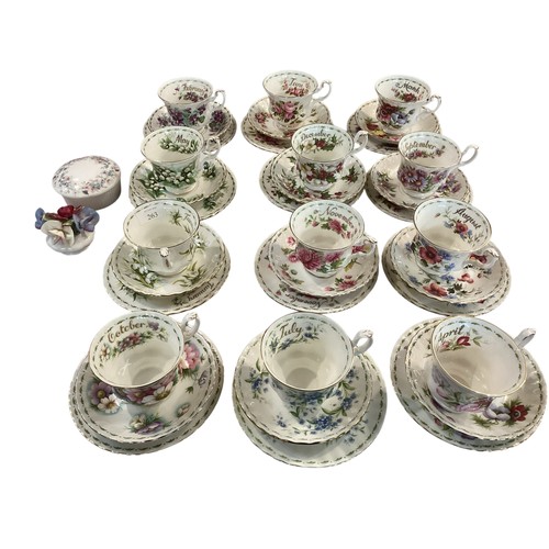 263 - A set of Royal Albert Bone china cups, saucers and plates, illustrated with a month for each set