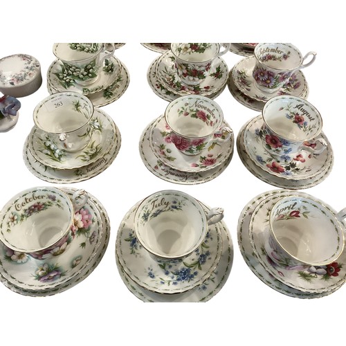 263 - A set of Royal Albert Bone china cups, saucers and plates, illustrated with a month for each set