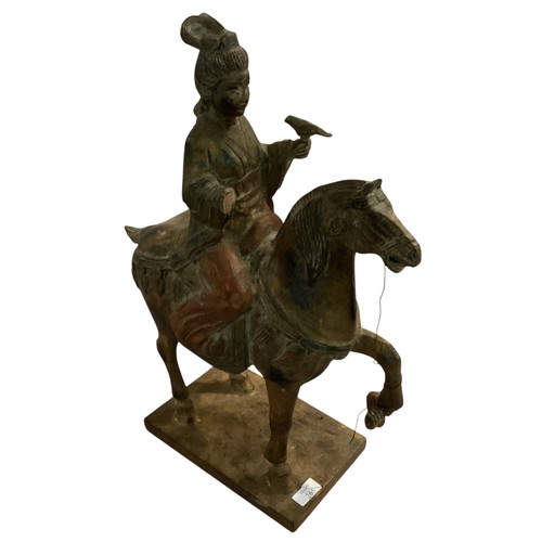 265 - A decorative wooden model of a horse and rider, in the style of a Chinese Tang horse. some damage to... 