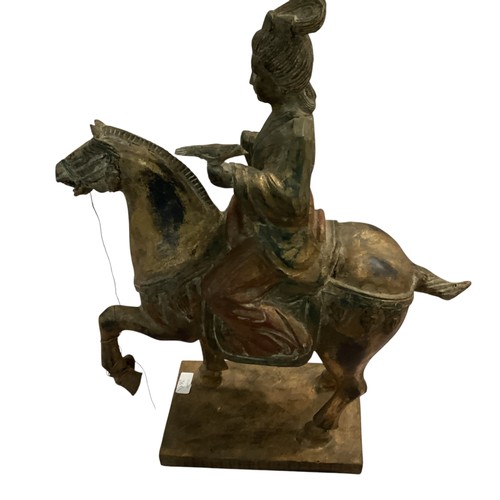 265 - A decorative wooden model of a horse and rider, in the style of a Chinese Tang horse. some damage to... 