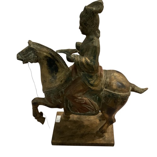 265 - A decorative wooden model of a horse and rider, in the style of a Chinese Tang horse. some damage to... 