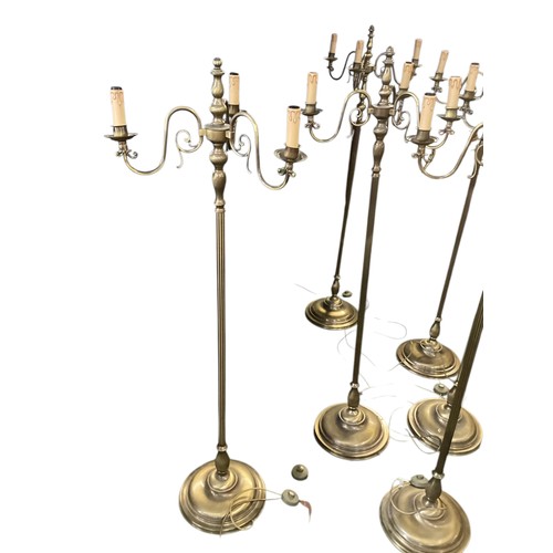 248 - A set of six brass column standard lamps each with 3 branches to faux candles. wired (not tested)