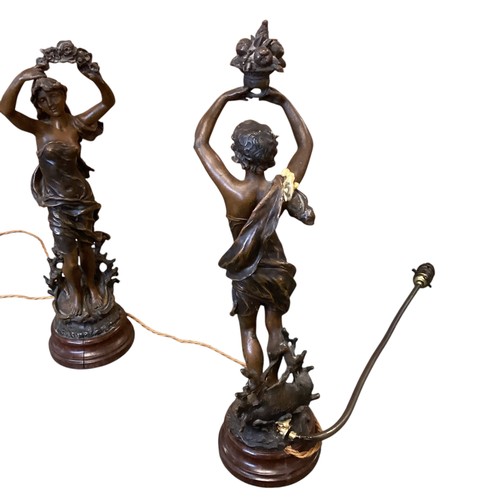 154 - A pair of modern figural table lamps, modelled as classical figures of a man and a woman, raised on ... 