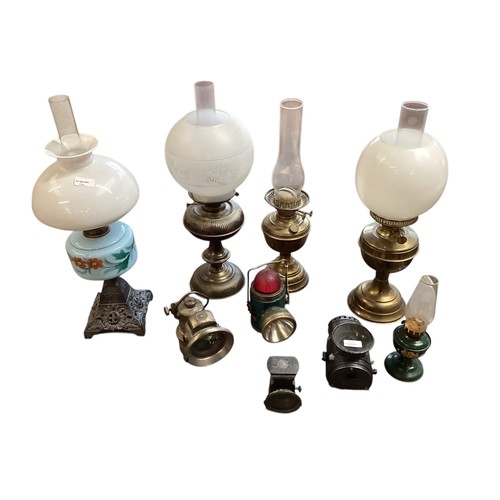 164 - A quantity of vintage lamps, to include brass and glass lamps, and four oil lamps with glass shades