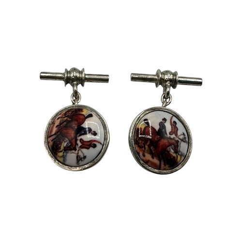 54 - A pair of silver cufflinks illustrated with equestrian hunting scenes