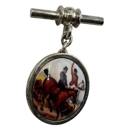 54 - A pair of silver cufflinks illustrated with equestrian hunting scenes