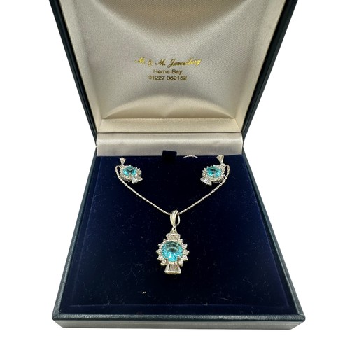 55 - A silver necklace with pendant, thistle shaped with blue stone, and matching earrings