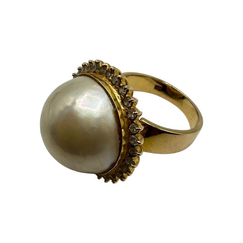 10 - An 850 marked .pearl and diamond dress ring. Central button pearl with a surround of single cut diam... 