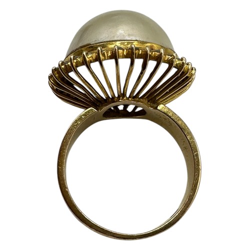 10 - An 850 marked .pearl and diamond dress ring. Central button pearl with a surround of single cut diam... 