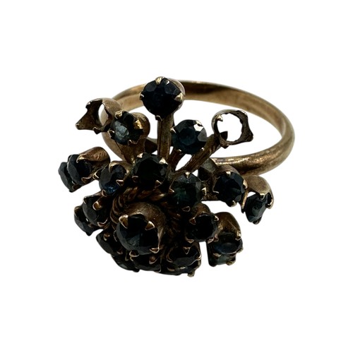 11 - A 14ct gold and sapphire cluster ring. Profusely set with single cut sapphires. Size O. 4.4g.