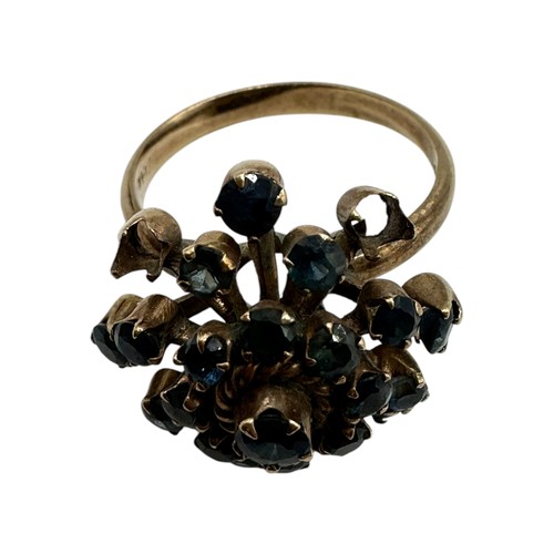 11 - A 14ct gold and sapphire cluster ring. Profusely set with single cut sapphires. Size O. 4.4g.