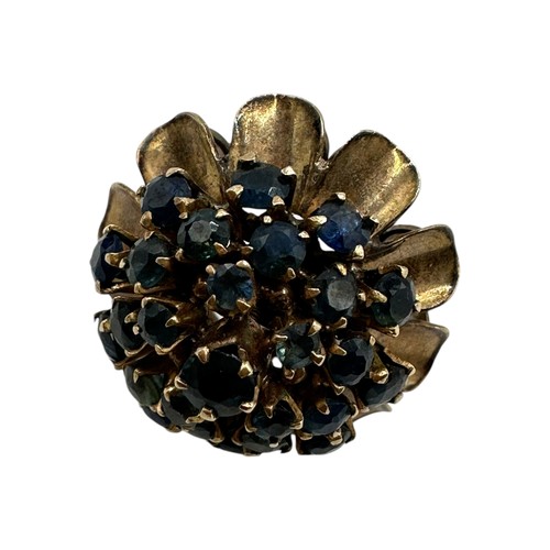 12 - An unmarked yellow metal and sapphire cluster ring set throughout with single cut round sapphires. S... 