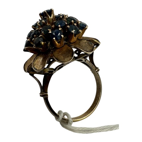 12 - An unmarked yellow metal and sapphire cluster ring set throughout with single cut round sapphires. S... 