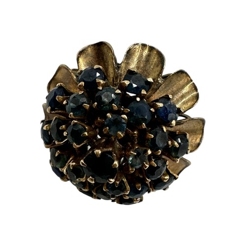 12 - An unmarked yellow metal and sapphire cluster ring set throughout with single cut round sapphires. S... 