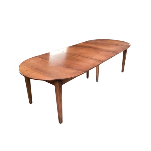 579 - An extending dining table.  111cm wide,
Fully closed with flaps down measures: 76cm Long.   275 cm L... 