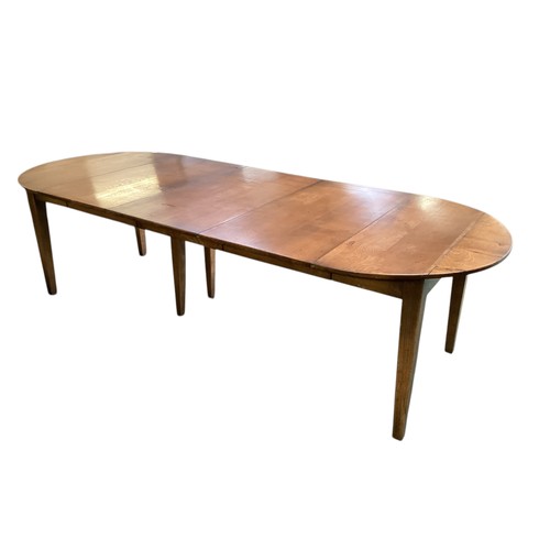 579 - An extending dining table.  111cm wide,
Fully closed with flaps down measures: 76cm Long.   275 cm L... 